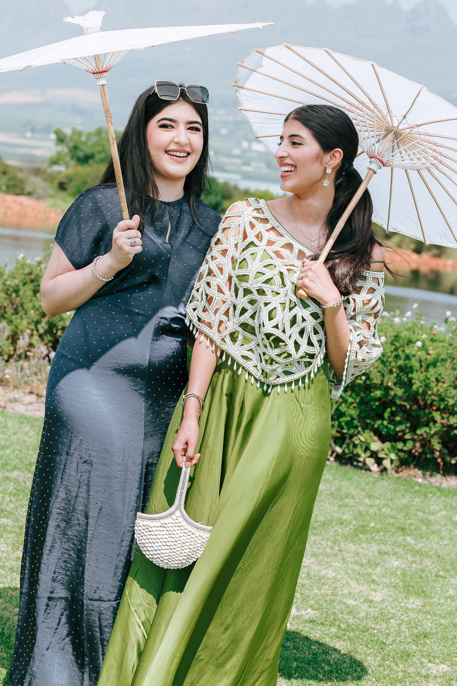 Guests laughing with parasols at a Cape Winelands wedding