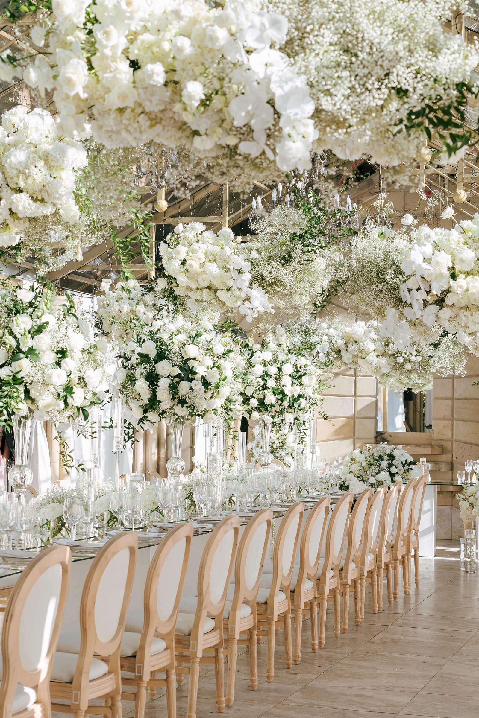A wedding reception under a ceiling of white florals, filmed by Lovoglio
